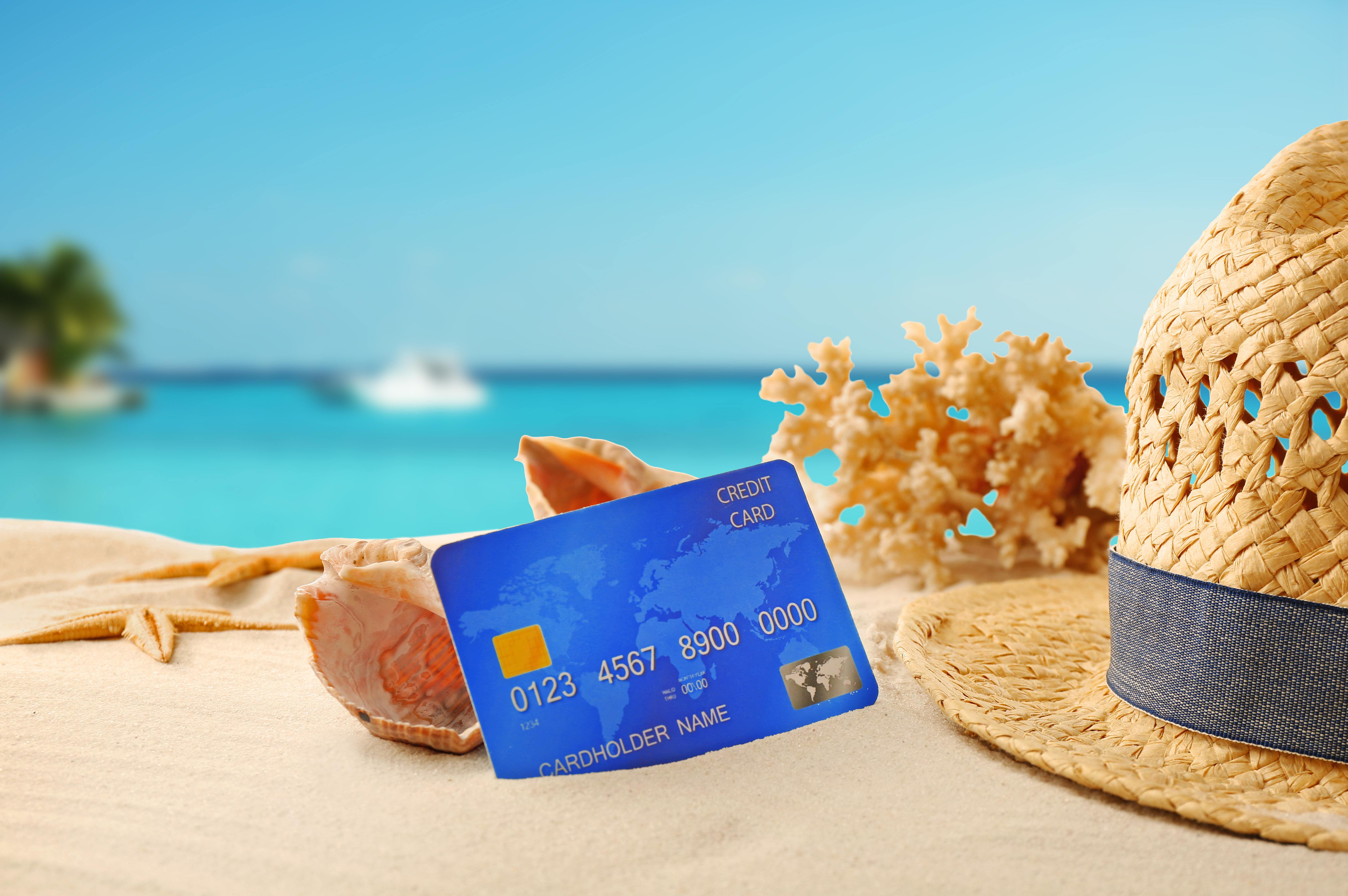 Credit card on holiday on blurred resort background