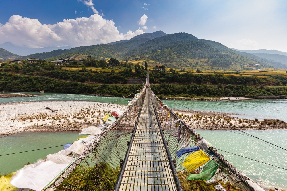 The Punakha Suspension Bridge at the Punakha Dzong. Across the Tsang Chu River to Shengana and Wangkha village. The longest suspension bridge in Bhutan and always decorated with colorful prayer flags.