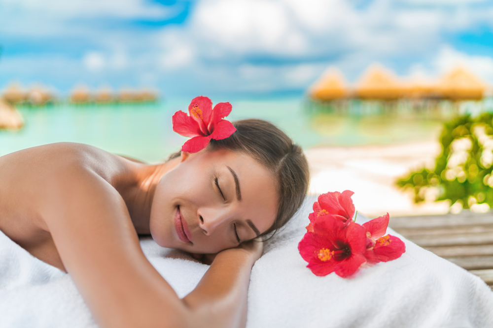 Luxury hotel spa massage table, Woman relaxing on exotic beach