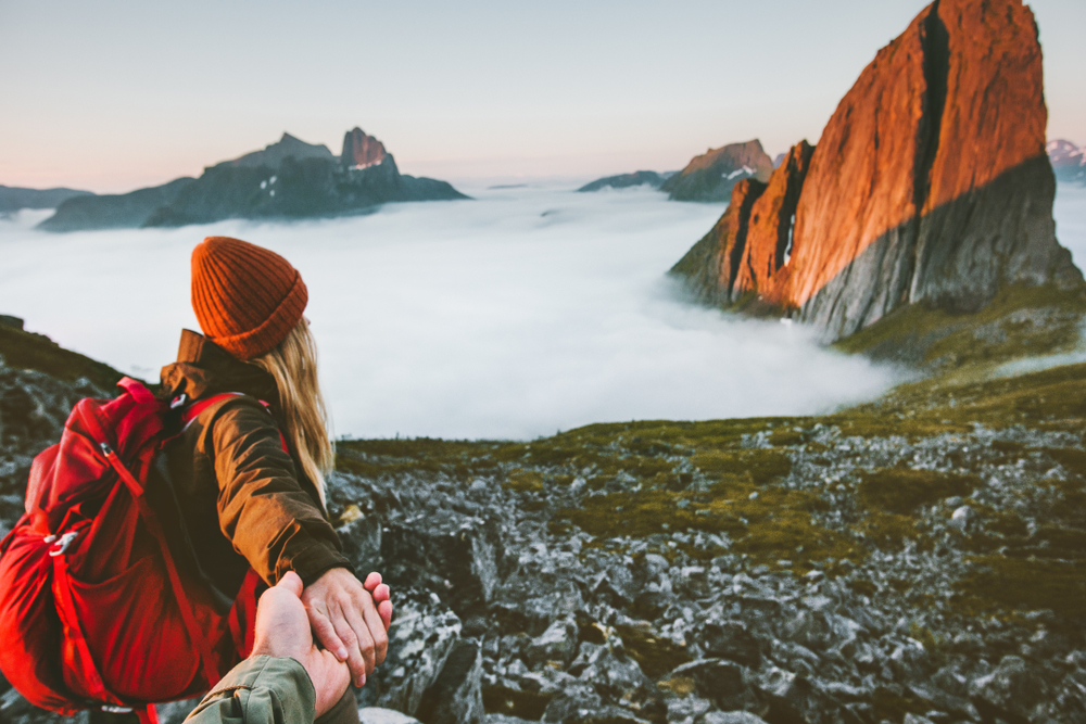 Couple romantic follow hands holding hiking in mountains