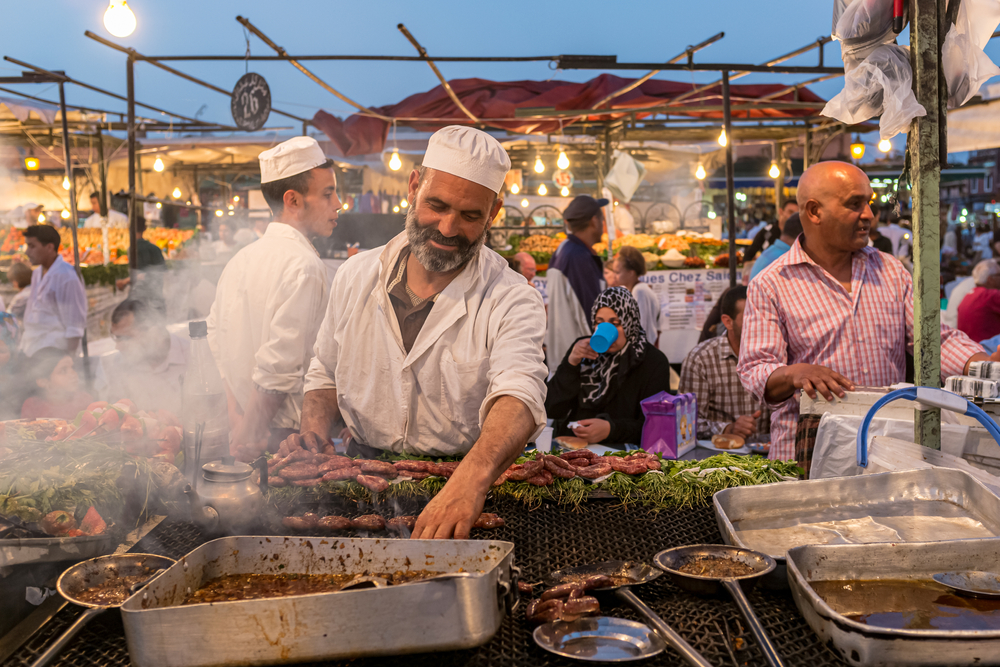 A cook at a food stall in Jemaa el-Fnaa, the main square of Marrakesh, Morocco. Street food stalls in Marrakech’s Djemaa el Fna square