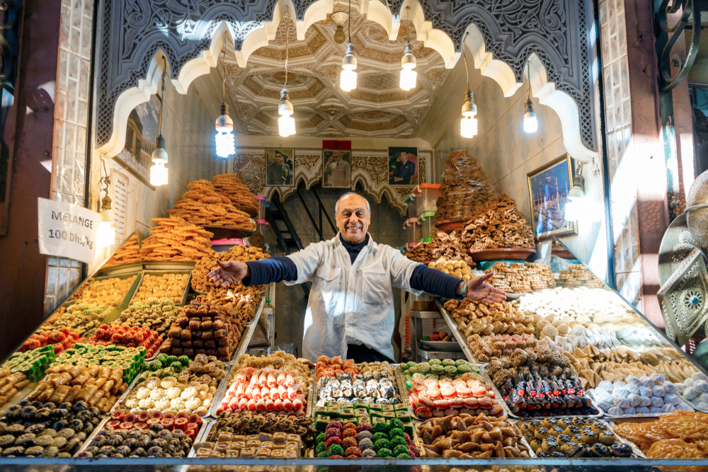 Man presenting his shop with delicious baklavas located in old town of Marrakech