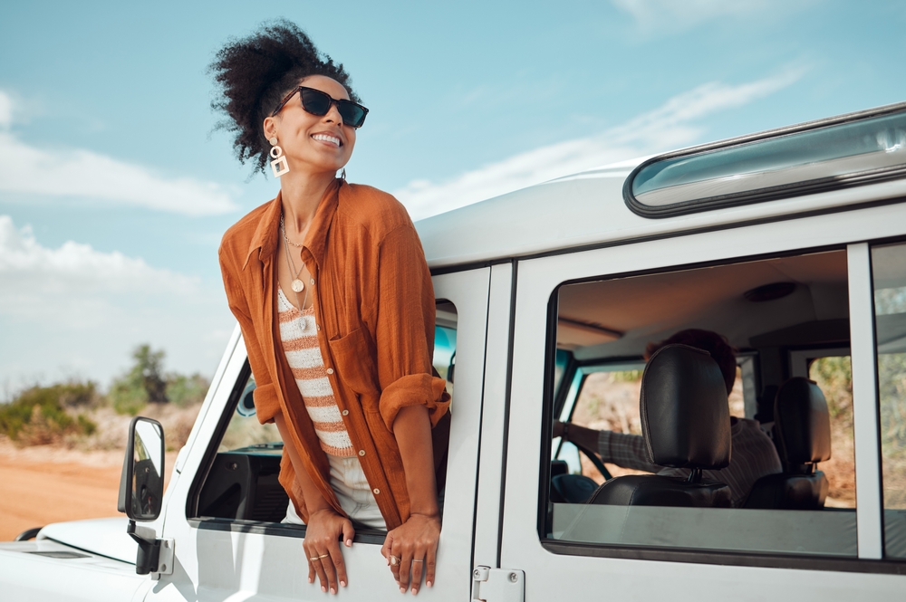 Black woman on road, enjoying window view of desert and traveling in suv on holiday road trip