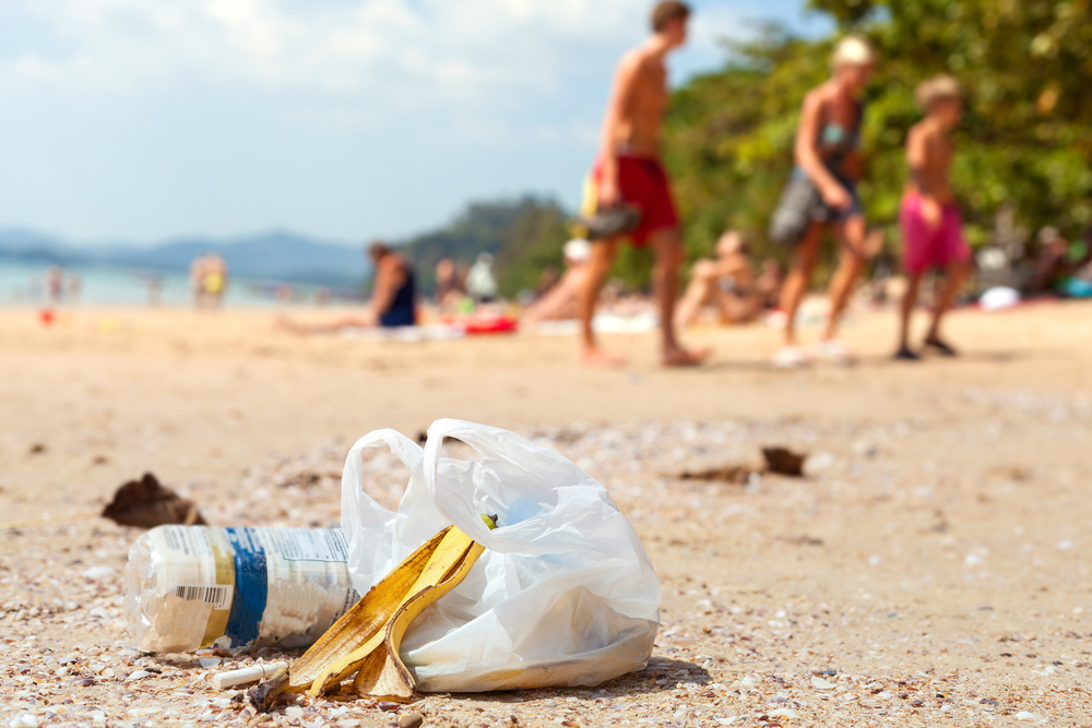 Garbage on a beach left by tourists, environmental pollution concept picture.