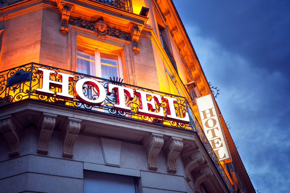 Illuminated hotel sign in Paris at night concept for vacation accomodation and business travel