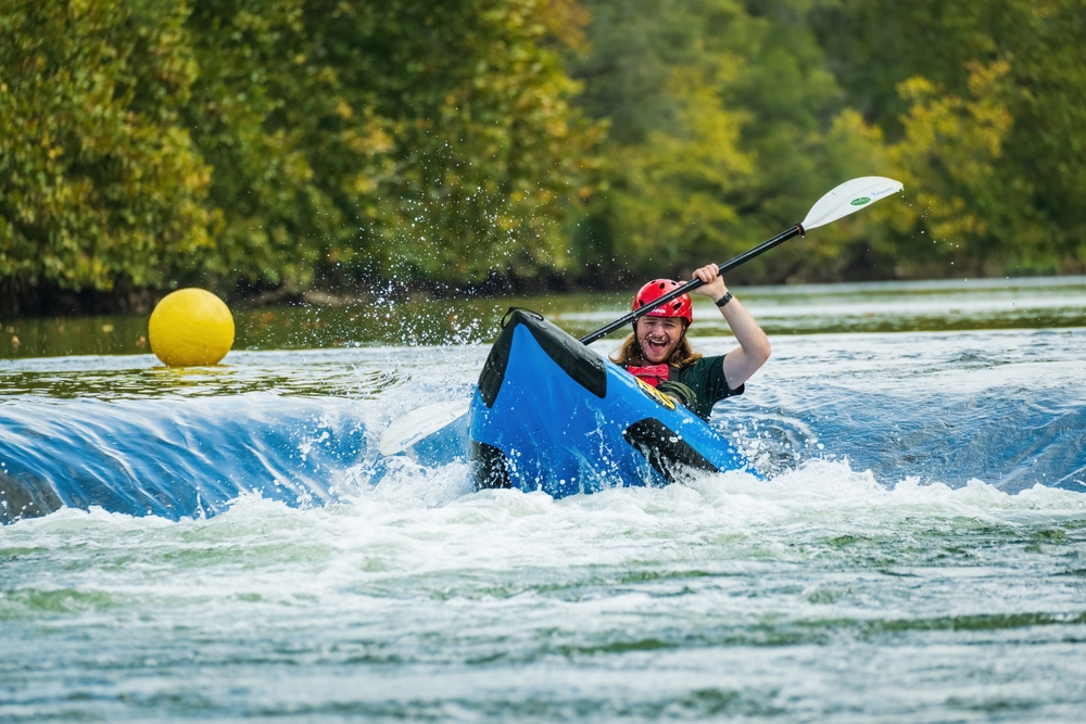 Man in Raft Going over whitewater feature at Eastwood Metropark on the Mad river During the Subaru Outdoor Experience