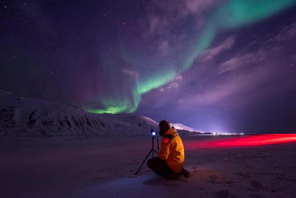 The polar arctic Northern lights hunting aurora borealis sky star in Norway travel photographer man Svalbard in Longyearbyen city the moon mountains