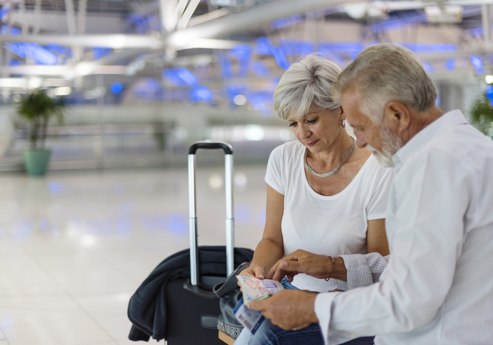 Senior couple traveling airport scene