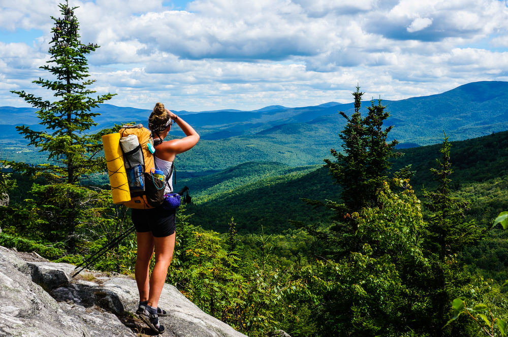 An Appalachian Trail Thru-Hiker looks back at New Hampshire just before she crosses into Maine