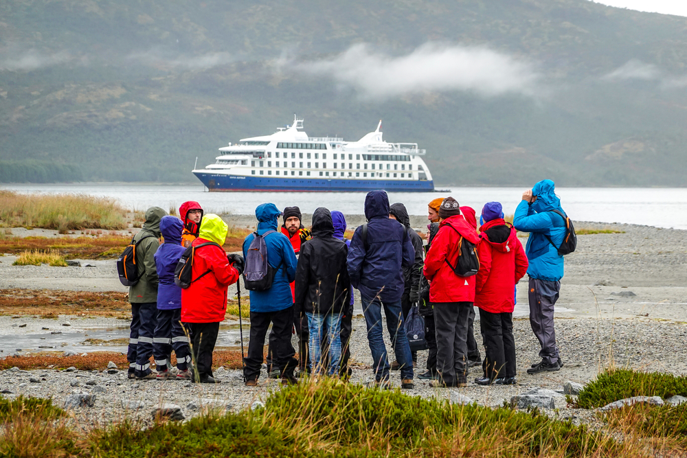 Tourists disembark from cruise ship "Ventus Australis" at Ainsworth Bay during fjords of Tierra del Fuego expedition cruise