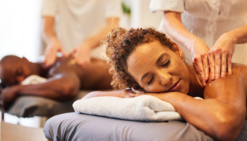 Black couple massage, spa and relax together on vacation, holiday or retreat for bonding, honeymoon or calm. Black woman, man or couple together for masssage therapy service, health and wellness