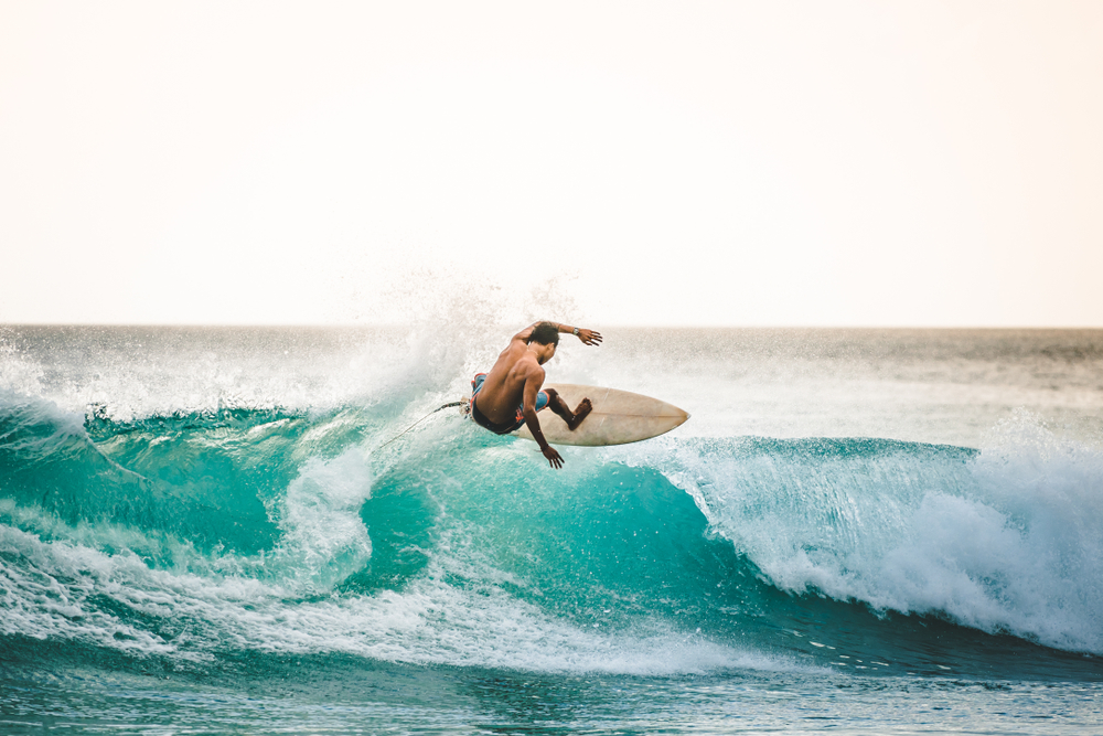 professional surfer riding waves in Bali, Indonesia.