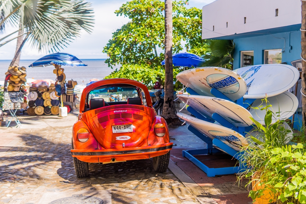 classic red VW Beetle (vocho) and surfboards in the magic town (pueblo magico of Sayulita)