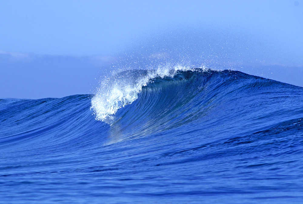 A view of a scenic blue ocean wave in Fiji