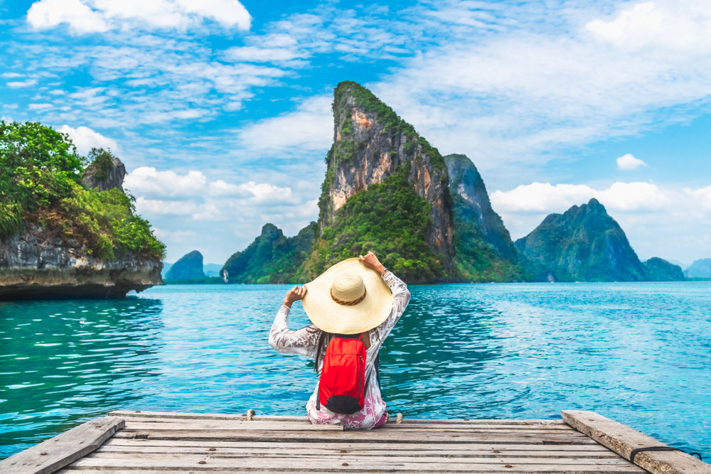 Traveler woman joy relaxing on wood bridge in beautiful destination island, Phang-Nga bay, Adventure lifestyle travel Thailand