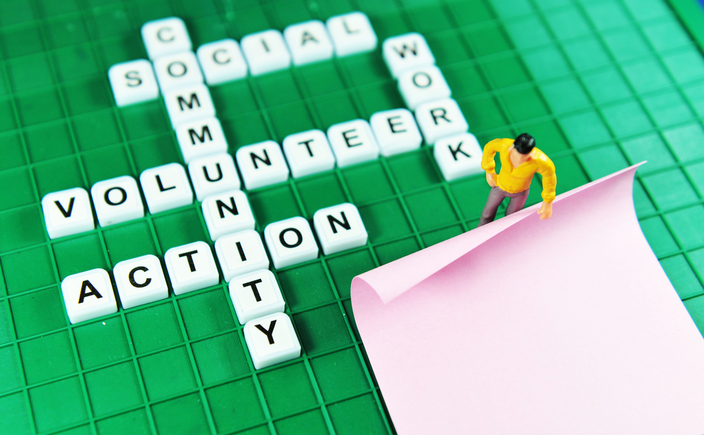 Volunteer key words on game boards and miniature people holding blank post-it