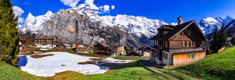 Switzerland nature and travel. Alpine scenery. Scenic traditional mountain village Murren surrounded by snow peaks of Alps.