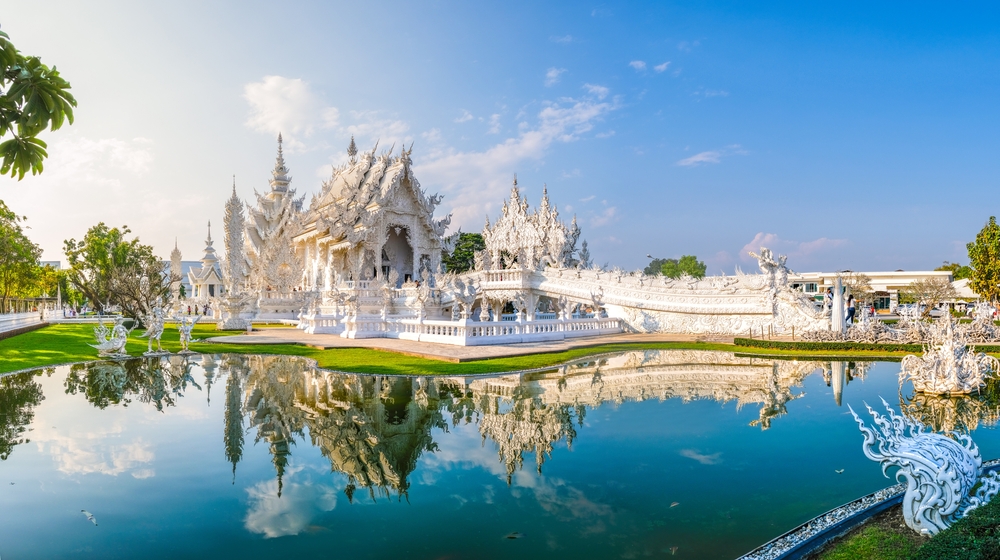 White Temple Chiang Rai Thailand, Wat Rong Khun Northern Thailand with reflection in the pond, panoramic view