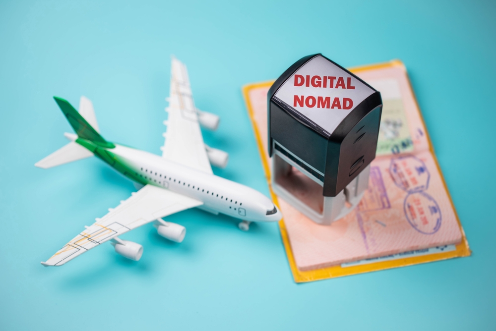 Travel passport pages, Visa stamps, stamper “Digital Nomad” and plane. Immigration, emigration, visa application and tourism concept.