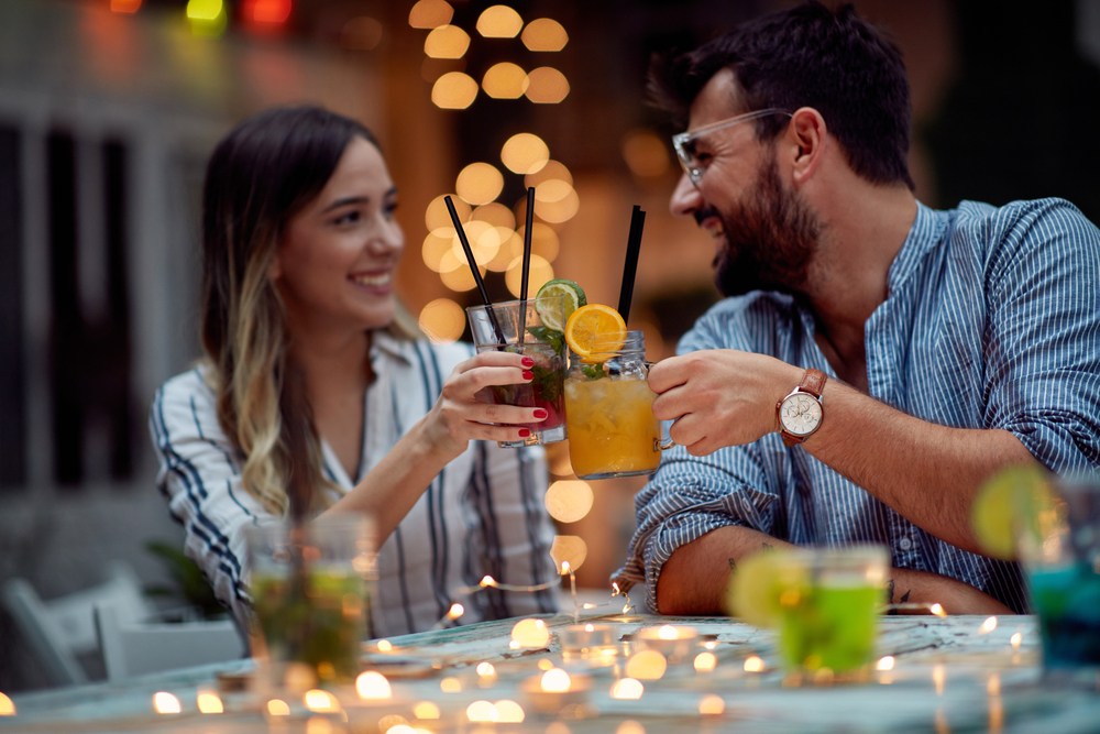 Young lovely couple making a toast at night party