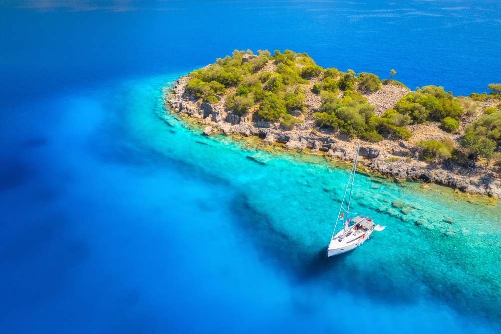 Aerial view of beautiful yacht on the sea at sunset in summer. Gemiler Island in Turkey. 