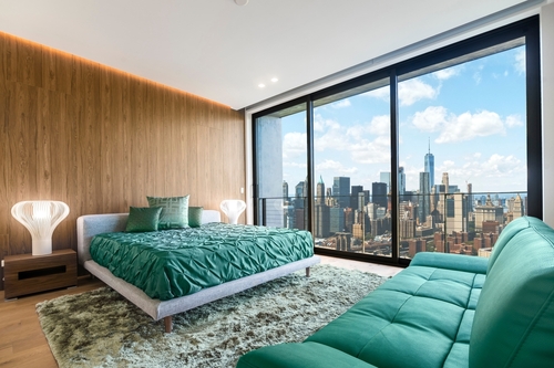 Modern and contemporary bedroom in Brooklyn, New York with views of upper Manhattan. 