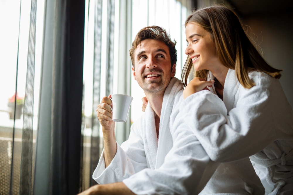 Relax, coffee and smile with couple at spa for luxury, vacation and romance.