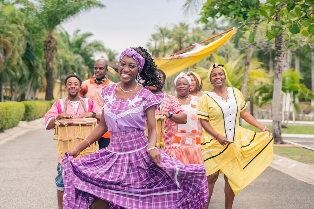 A Group of African American people dancing and playing Latin music.