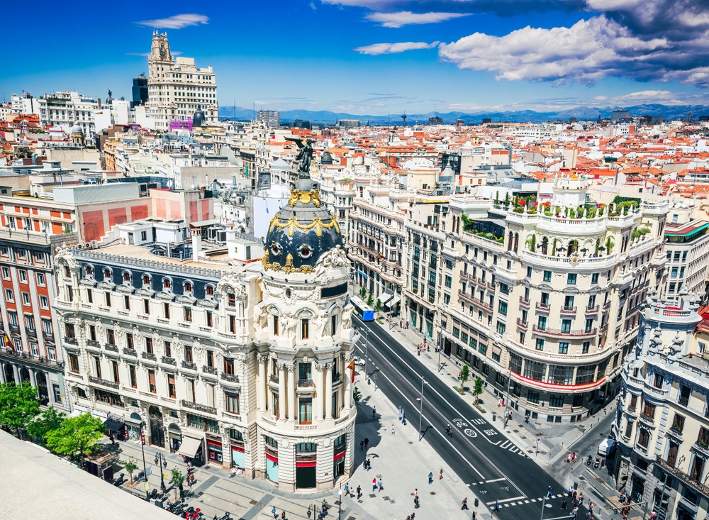 Madrid, Spain. Skyline of Madrid with Edificio Metropolis and Gran Via, summer sunny day, cloudscape sky.