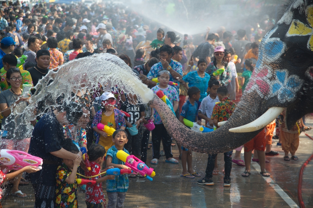 Thai people and traveler join with Songkran Festival is celebrated in a traditional New Year's with the splashing water by elephants in Ayutthaya , Thailand.