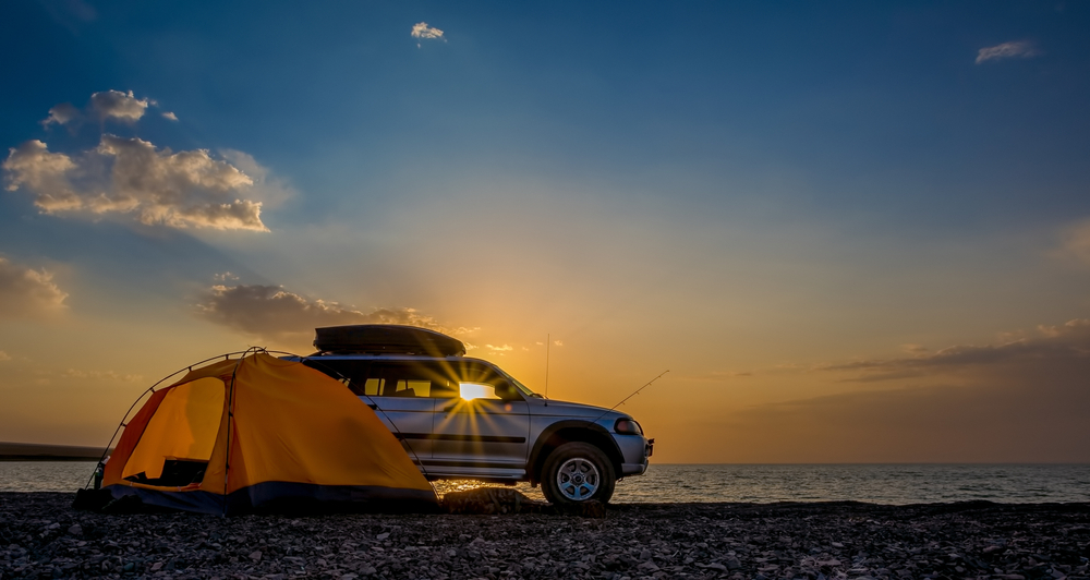 Adventures Camping tourism and tent and car next to the lake. Landscape outdoor in morning