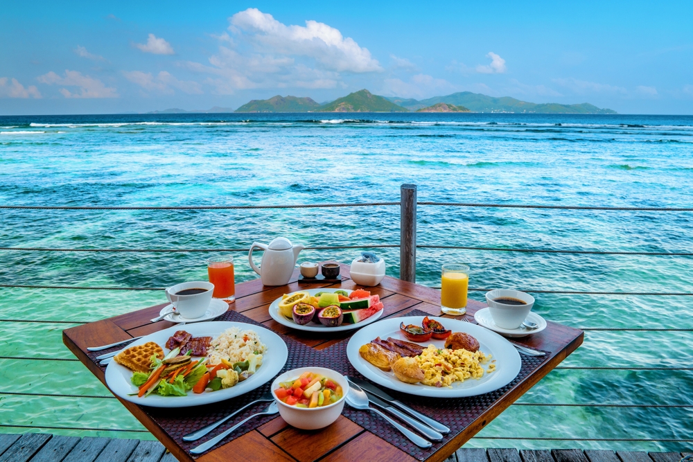 Breakfast on the beach by the pool with a look over the ocean of La Digue Seychelles,tropical Island