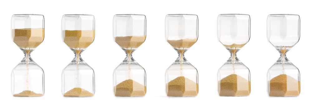 Passage of time. Hourglass with flowing sand