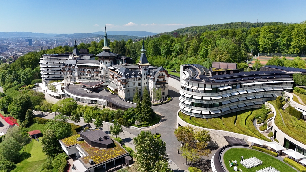 Aerial profile view of the luxurious Dolder Grand Hotel on a bright summer day