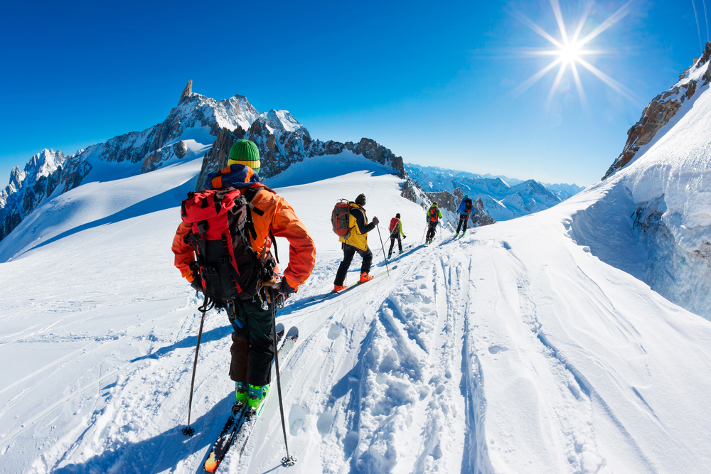 A group of skiers start the descent of Valle Blanche, the most famous offpist run in the Alps, Valle Blanche descent links Italy and France through the Mont Blanc Massif.