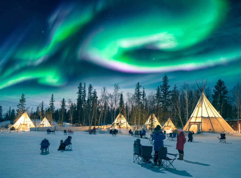 Amazing northern lights dancing over the tepees at Aurora Village in Yellowknife.