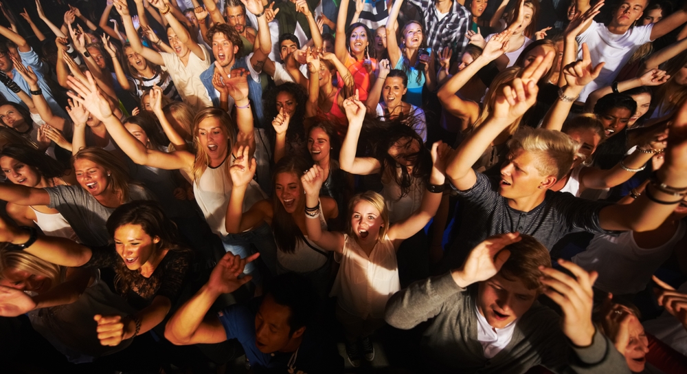 Music, dance and party with crowd at concert for rock, live band performance or festival.