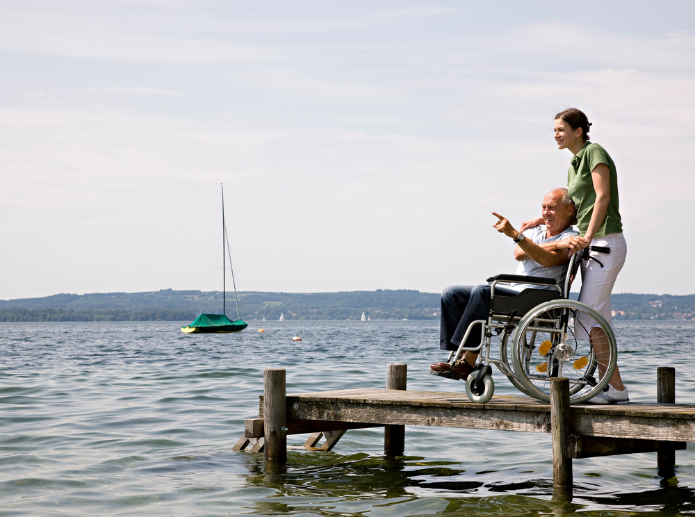 woman and senior man in wheelchair