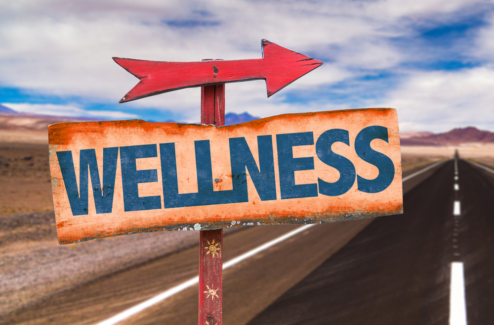 Wellness sign with road background