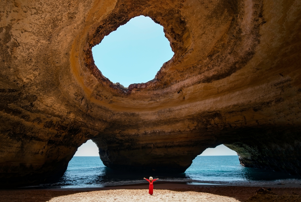 Traveler woman enjoying alone the beaches of the Algarve, Portugal