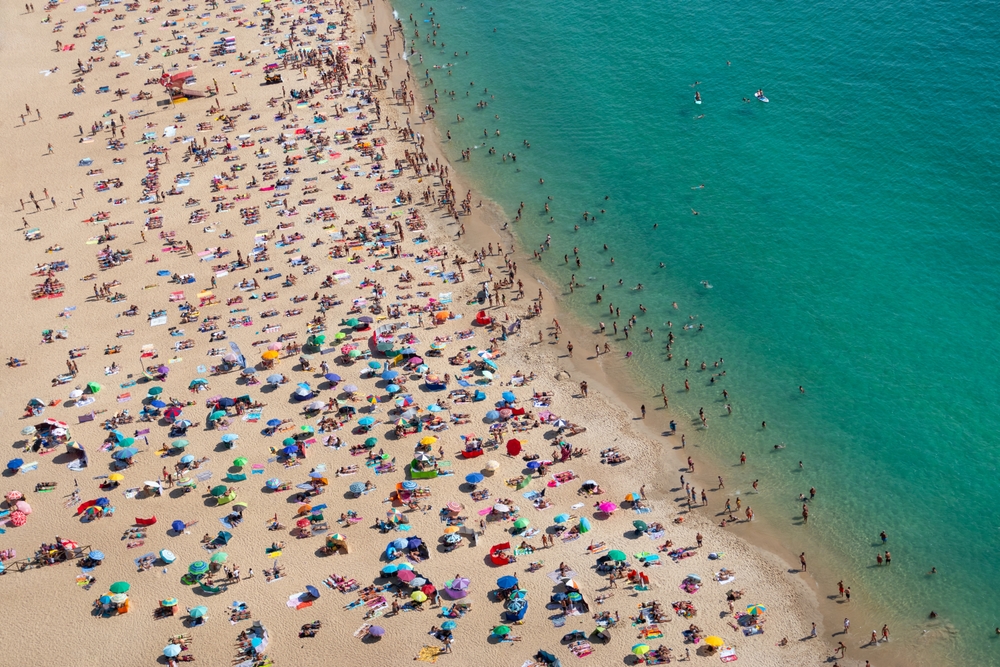 Aerial view of a crowded beach from above, praia de Nazaré, Portugal, Europe