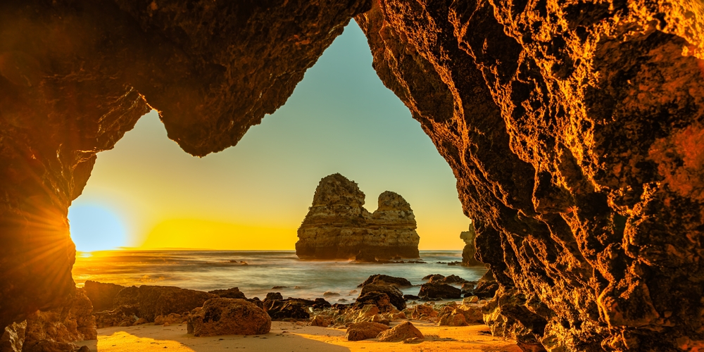 A beautiful shot of sunset scene at the rocky beach - Praia do Camilo beach near Lagos, Algarve, Portugal. Travel concept.