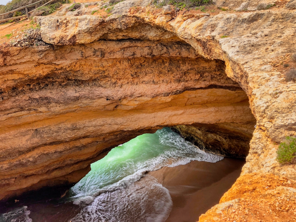 Magical cave in Algarve, Portugal. You can see what’s inside from the whole in the stone and enter inside only by the ocean (by boat or swimming)