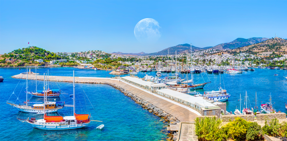 Panoramic view of Saint Peter Castle (Bodrum castle) and marina with full moon - Bodrum, Turkey