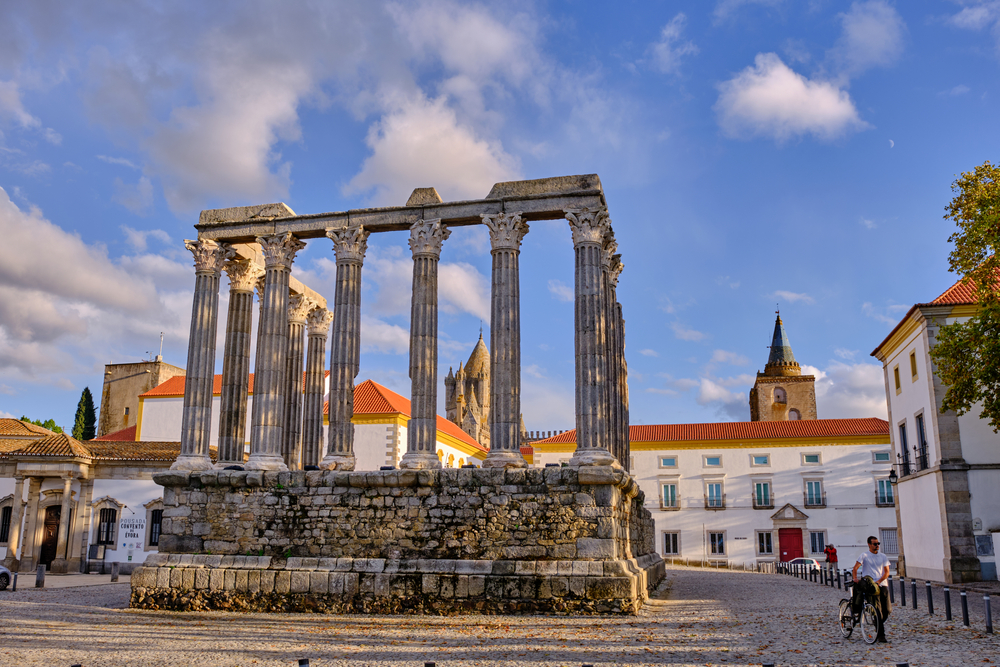 Evora , Portugal 2020-10-22 ruins of the Roman temple of Evora, on the right a person walking with a bicycle