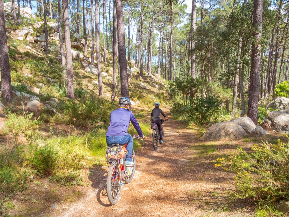 Couple riding mountain bikes in Sintra, Portugal.