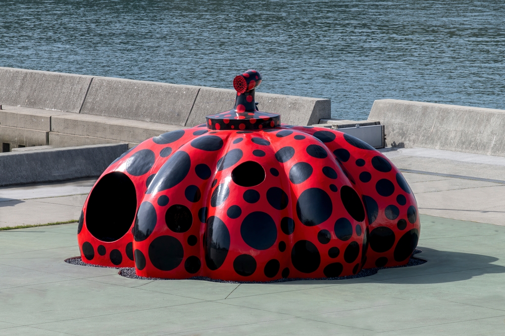 High angle view of sculpture of a red pumpkin by artist Yayoi Kusama where the ferry enters Miyanoura Port on the island known for modern art
