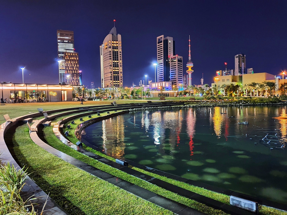  Landscape architectural design with view of skyscrapers inside of Al Shaheed Park, the largest urban park in Kuwait.