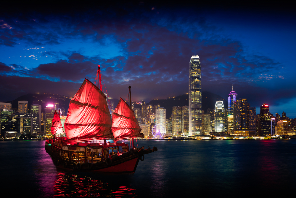 Victoria Harbour Hong Kong night view with junk ship on foreground