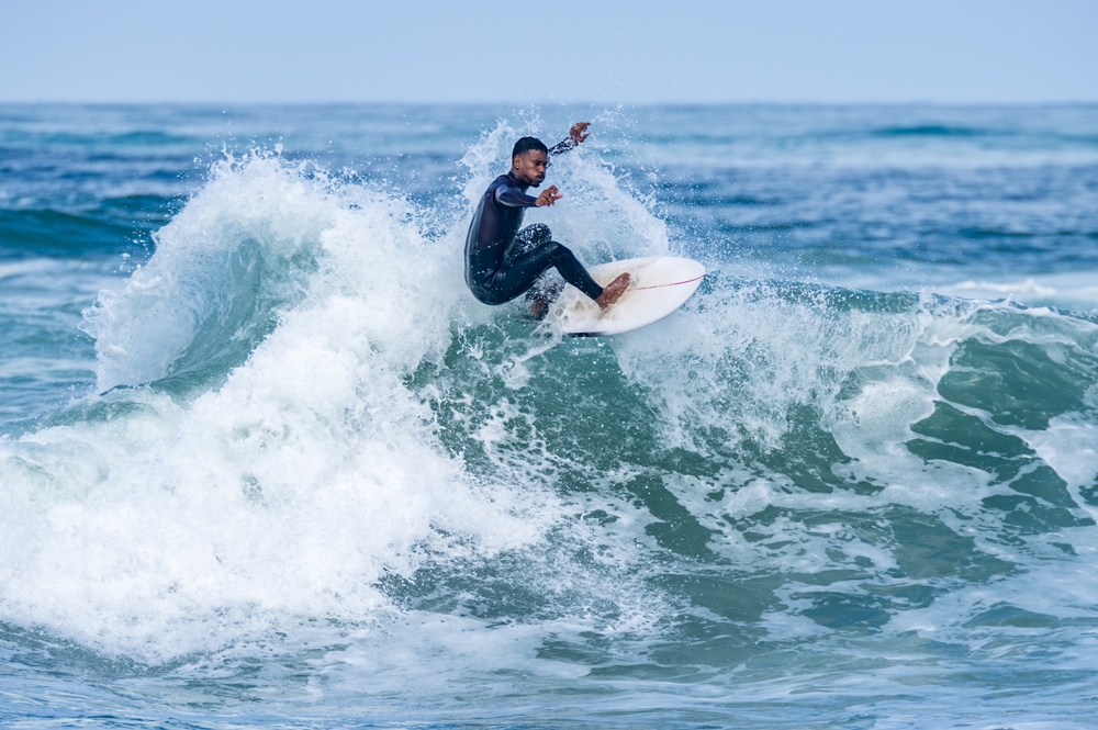 Surfer riding waves in Furadouro Beach, Portugal.